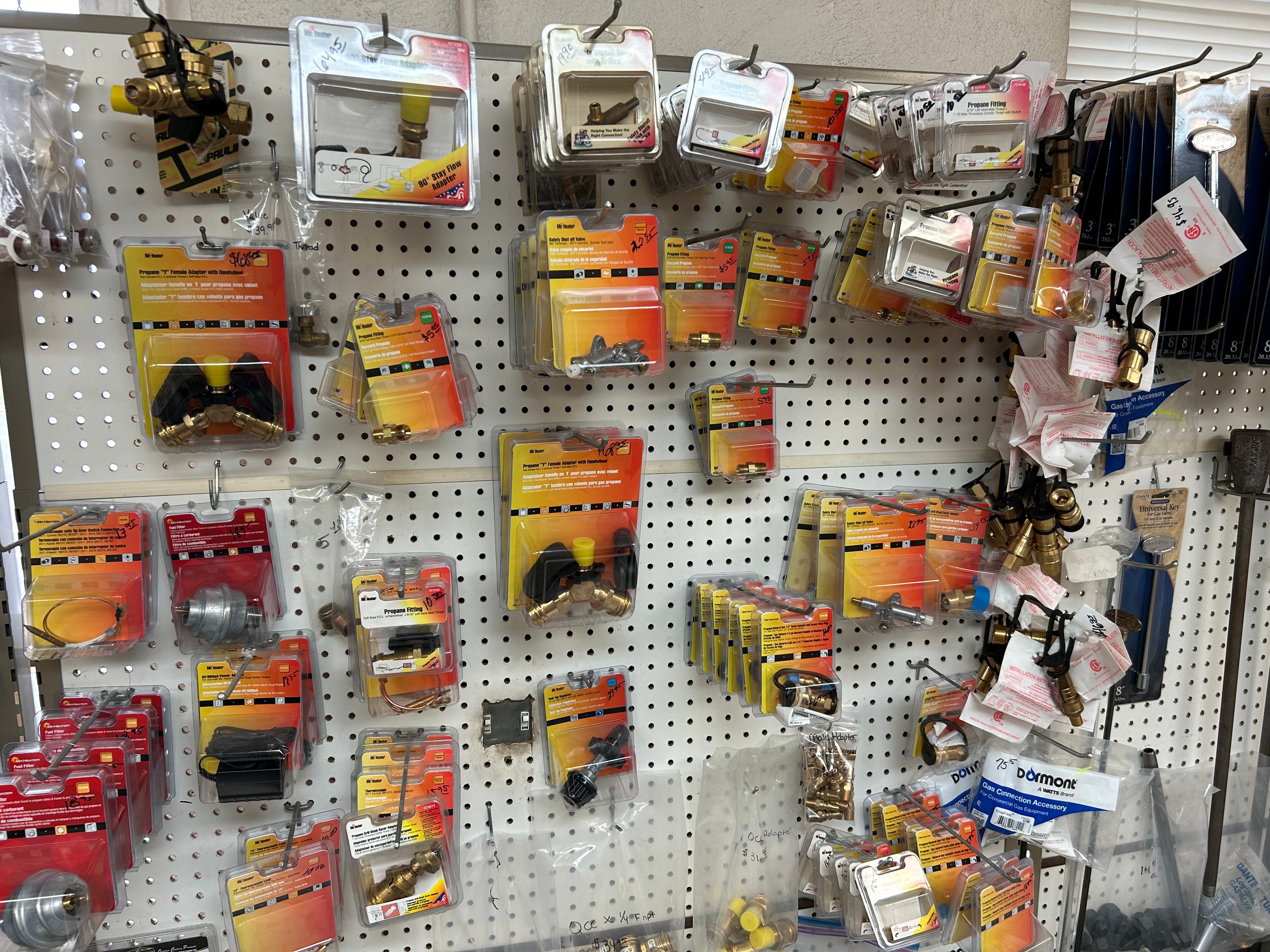 Propane valves, adapters, and fittings display at Action Propane storefront