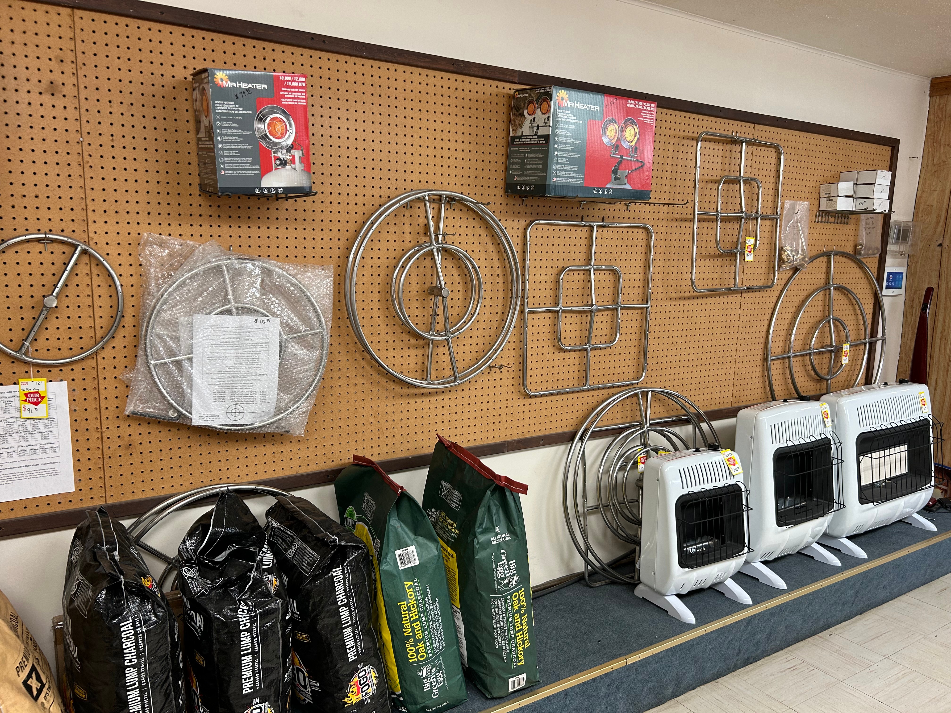 Propane heaters, fire rings, and charcoal display at Action Propane, Leander TX