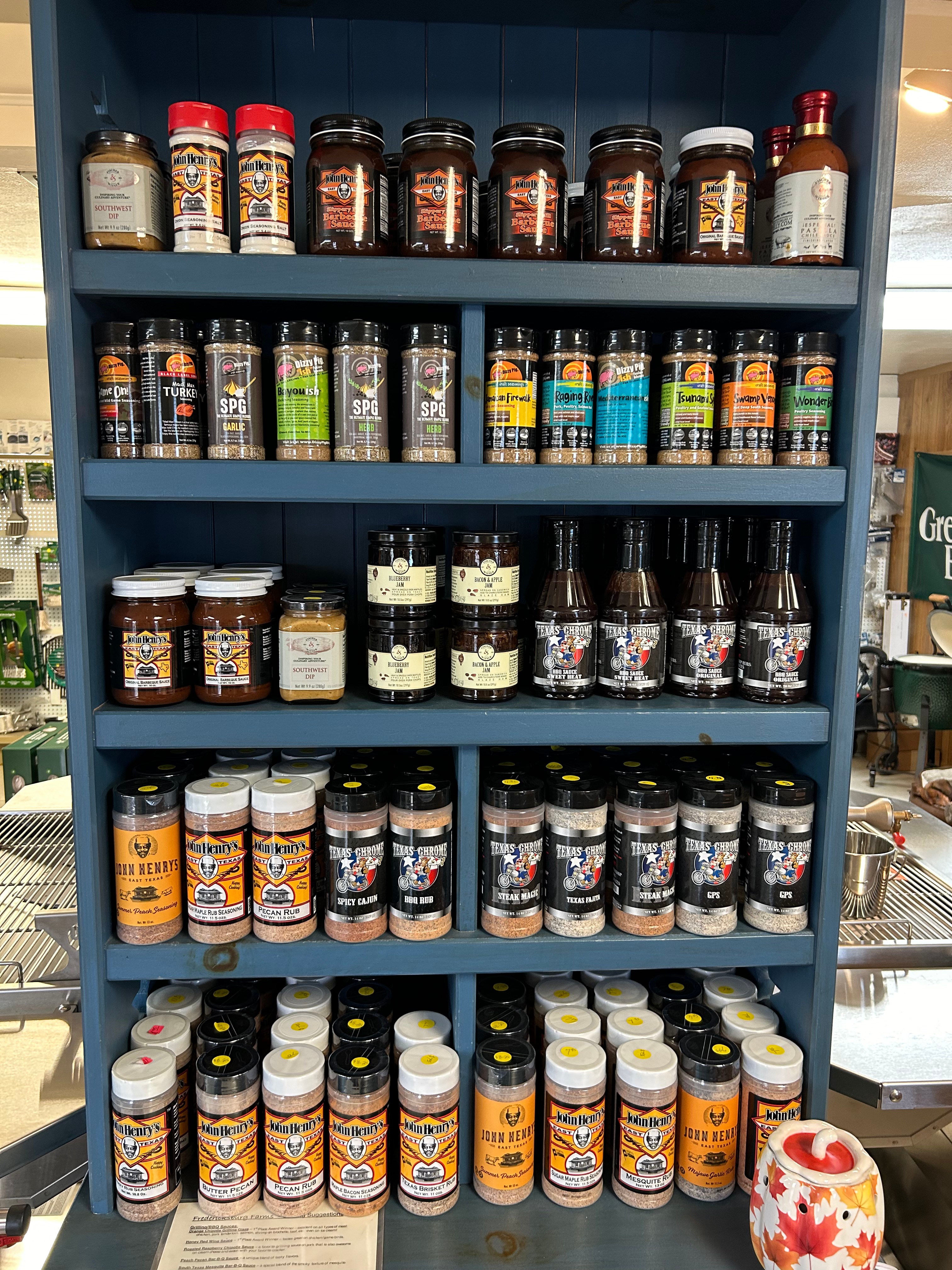 BBQ rubs, sauces, and seasonings shelf inside Action Propane in Leander TX