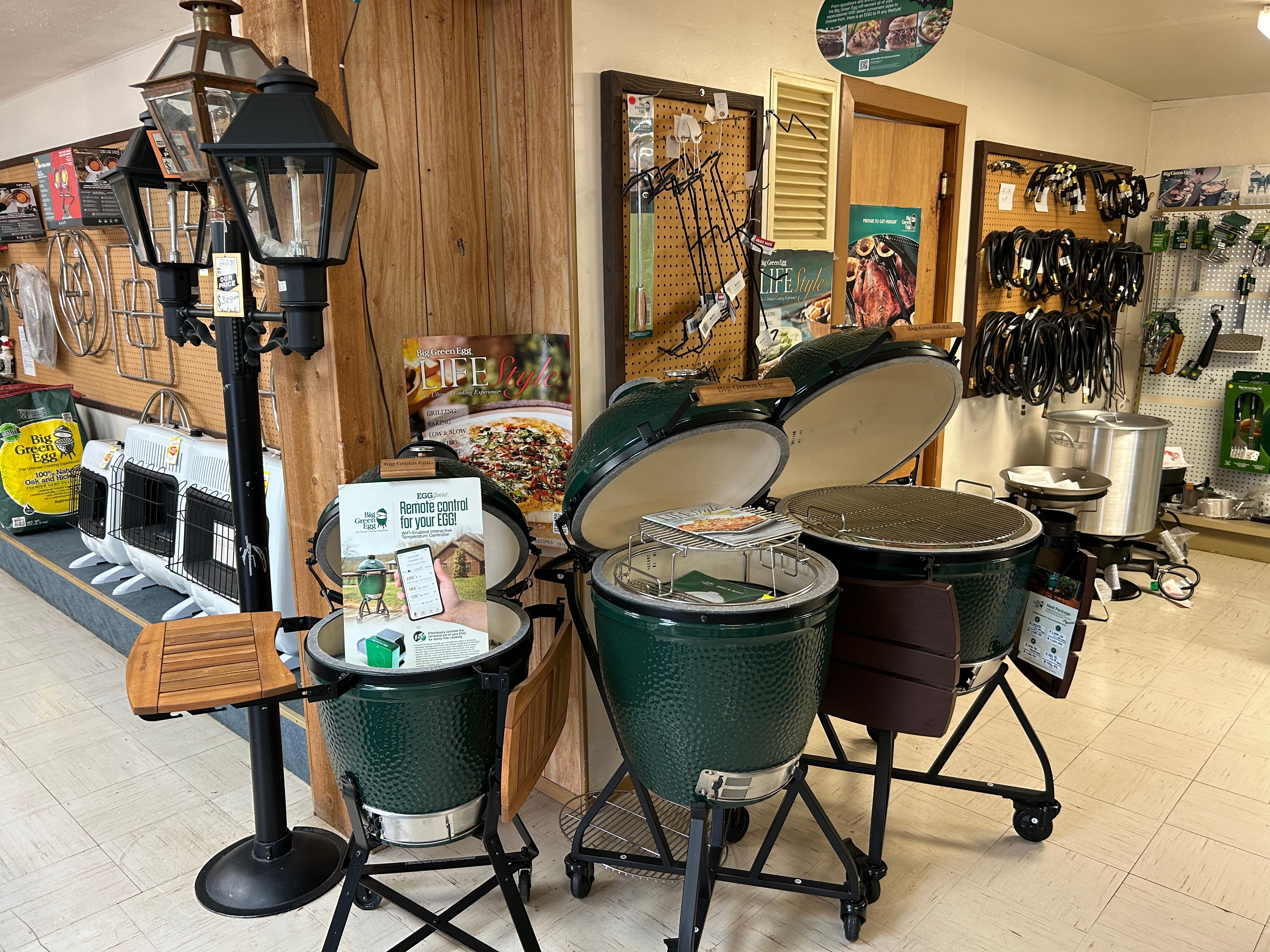 Big Green Egg grills open on stands in Action Propane showroom, Leander TX