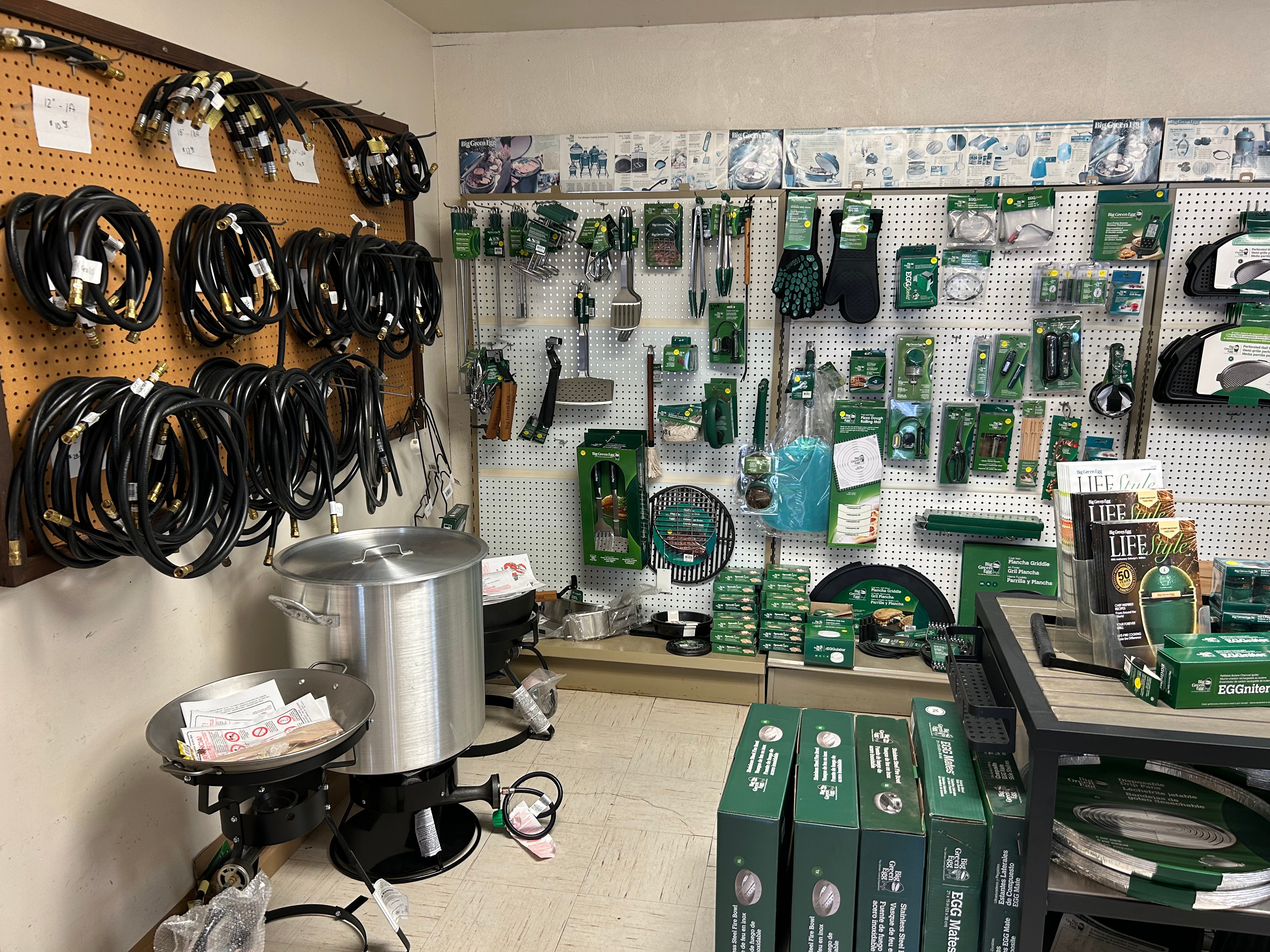 Big Green Egg accessories room with hoses, EGG tools, and cookware at Action Propane